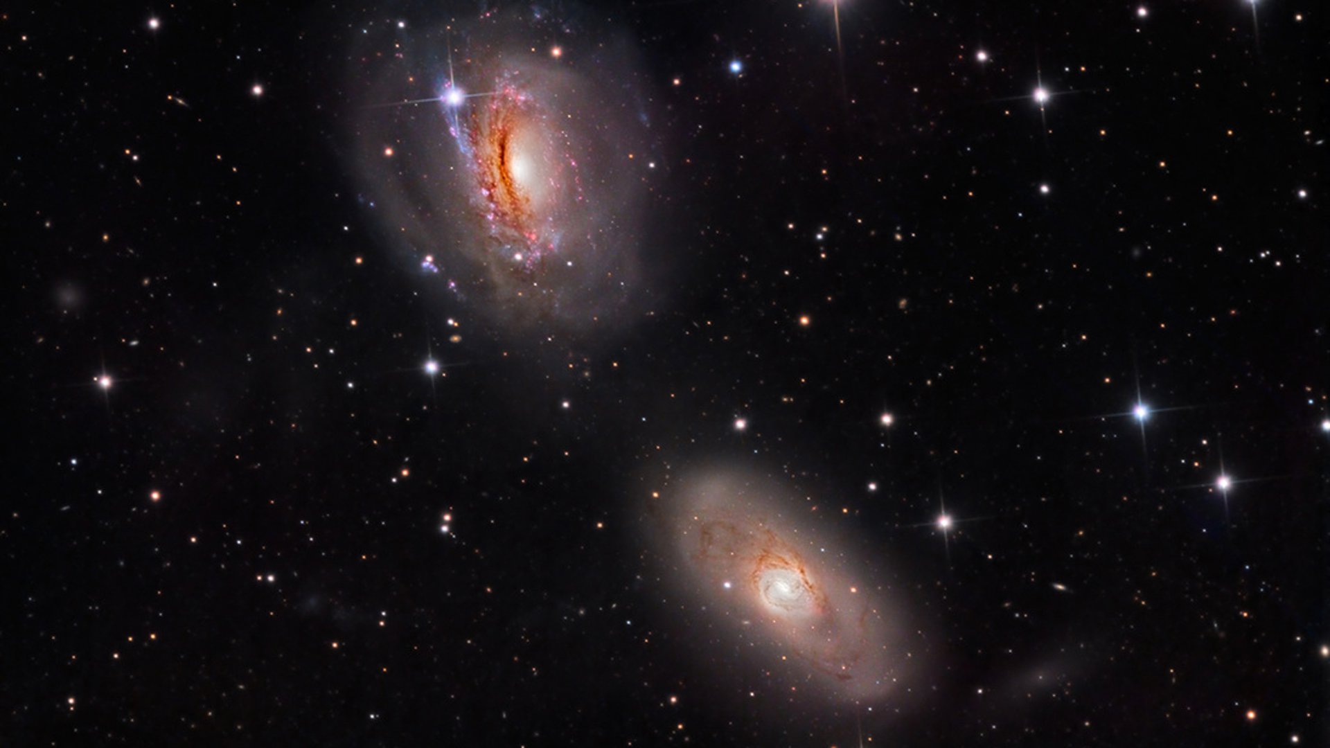 Gravitationally Bound Spiral Galaxies NGC 3169 (Top) and NGC 3166 (Bottom) Playing Tug-Of-War
