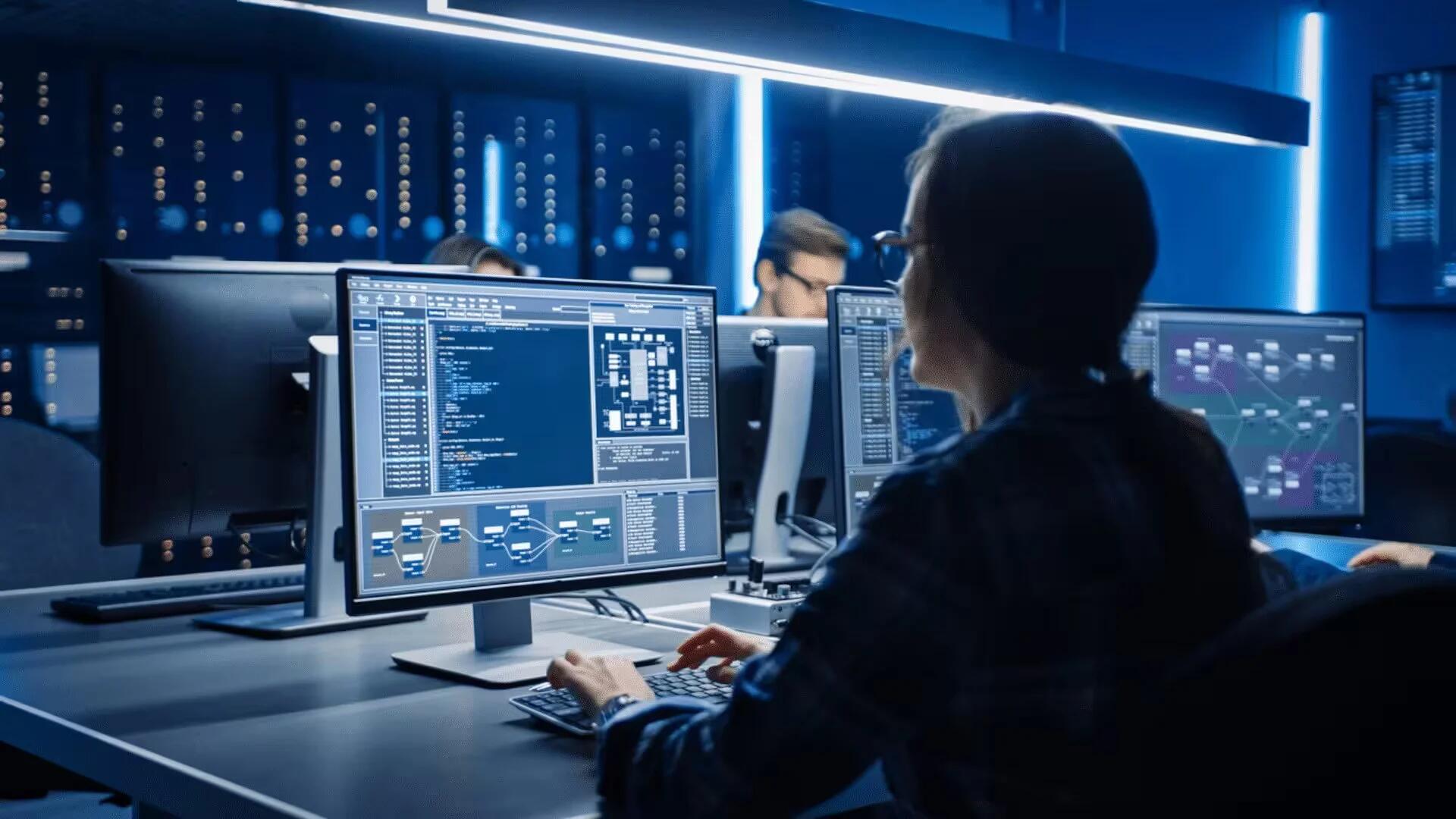 Smart Female IT Programer Working on Desktop Computer in Data Center System Control Room.