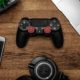 Black Game Controller on Wooden Surface / Photo by Garrett Morrow from Pexels