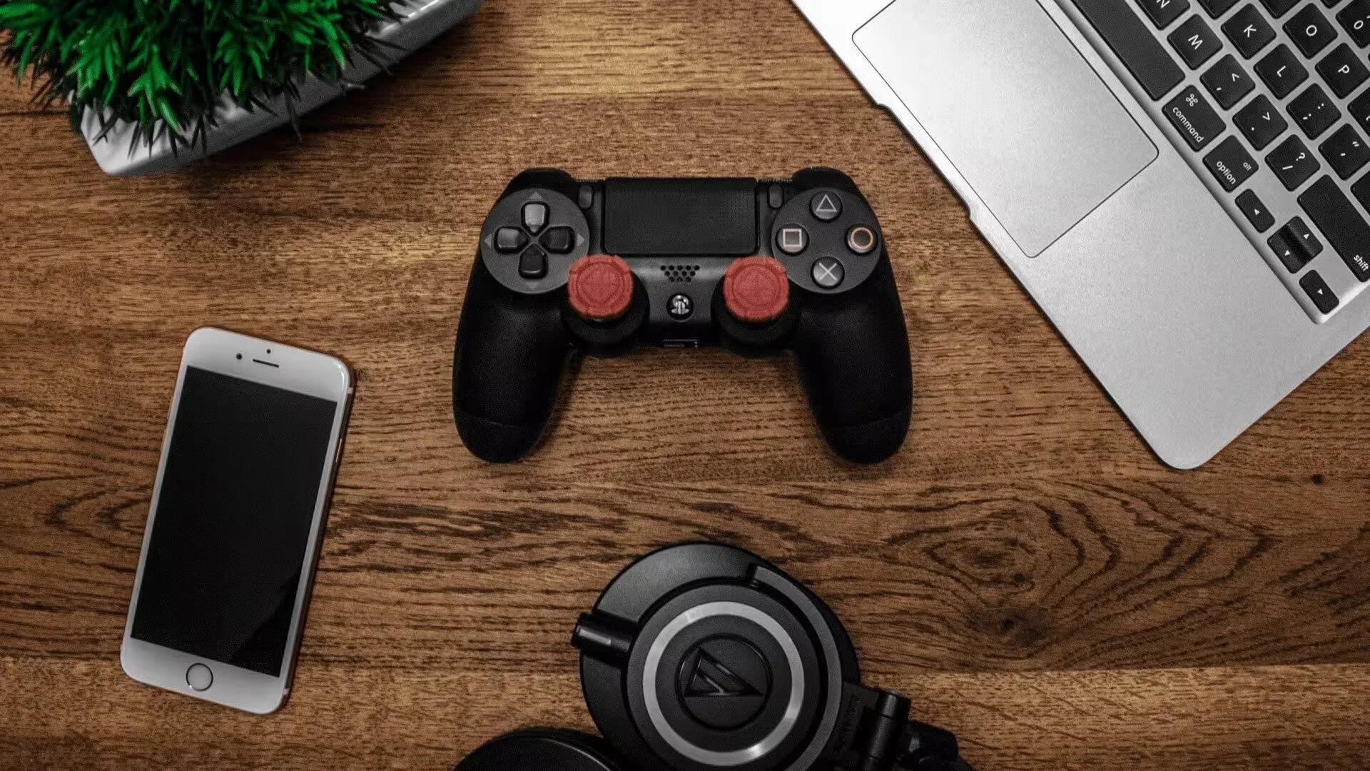 Black Game Controller on Wooden Surface / Photo by Garrett Morrow from Pexels