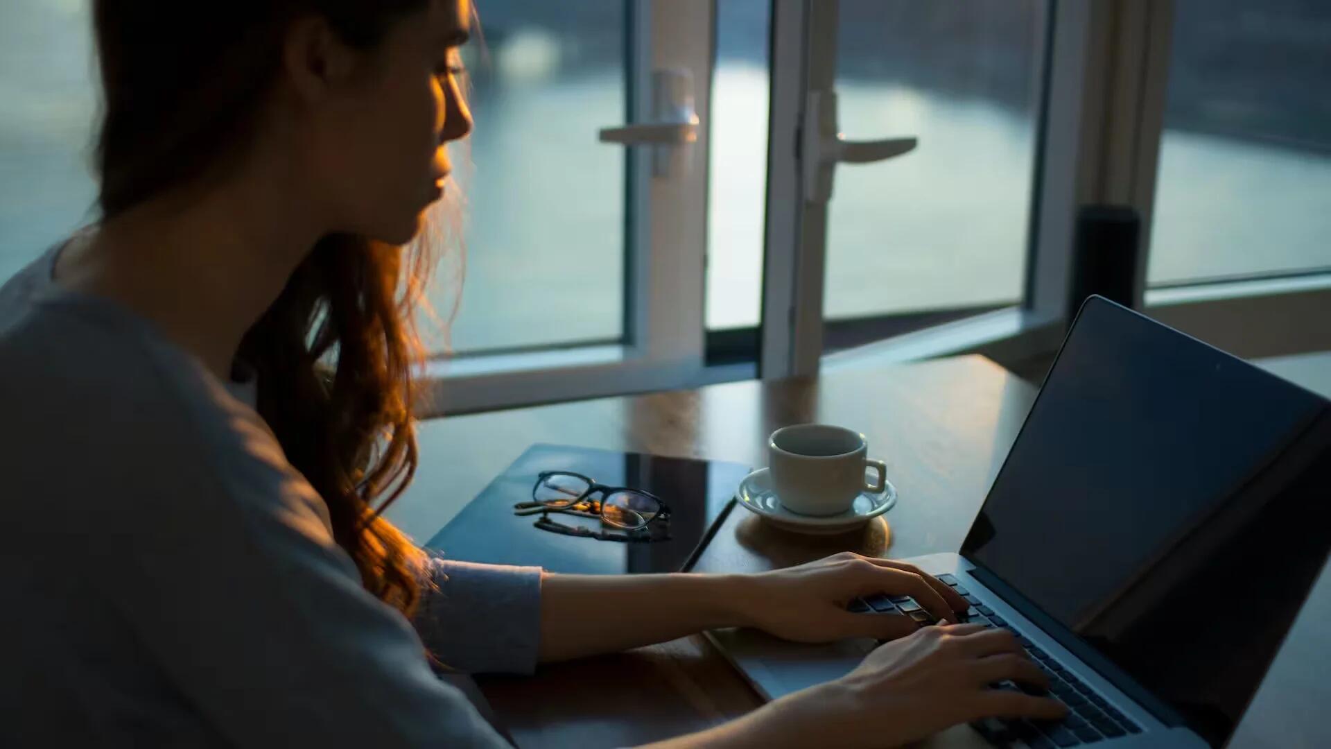 A woman writing on a PC