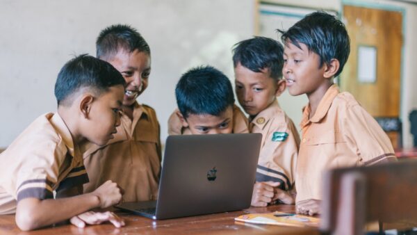 Students Looking At Macbook / Photo by Agung Pandit Wiguna from Pexels