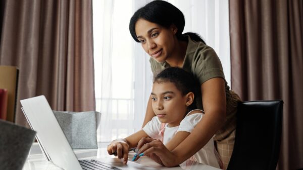 Mother Helping Her Daughter Use A Laptop / Photo by August de Richelieu from Pexels